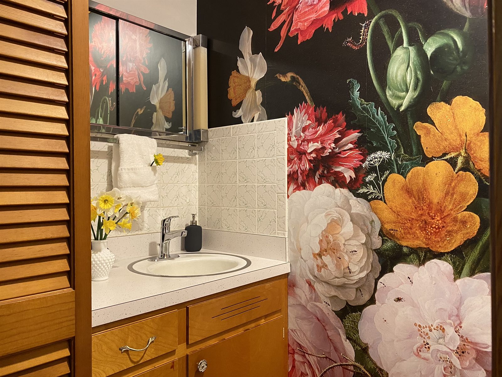 A powder room with a bold botanical mural